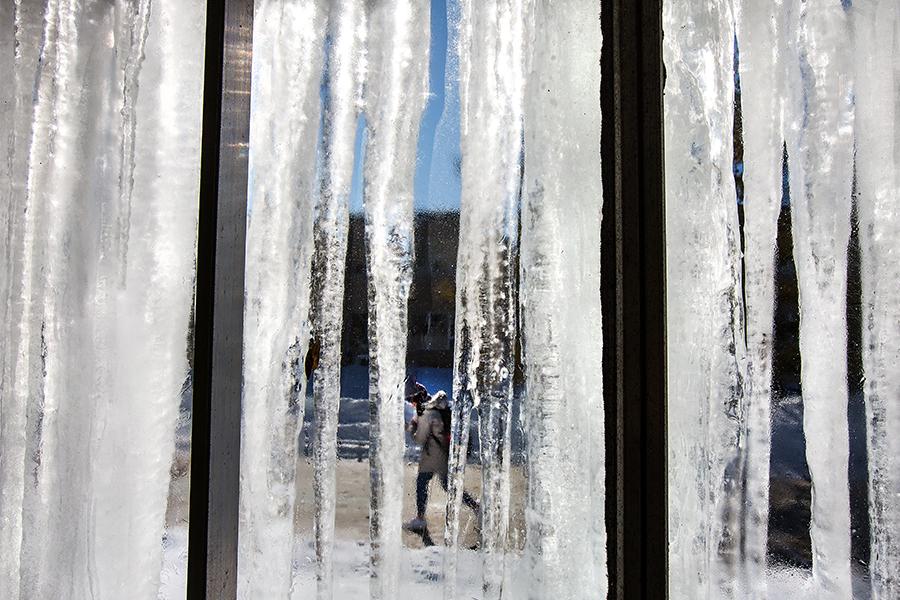 Icicles hang off a building.